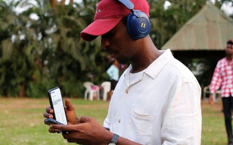 Young man outdoors taking the Wimentor career assessment on his phone